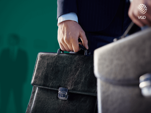 a male hand carrying a business briefcase
